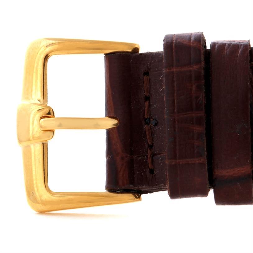 This image shows a close-up of the buckle and leather strap of a President model by Rolex.