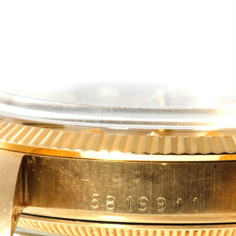 This image shows a close-up of the side of a Rolex President 1503 Men
s Yellow Gold Champagne Dial 1503 Men
s Yellow Gold Champagne Dial watch case, highlighting the serial number and fluted bezel.