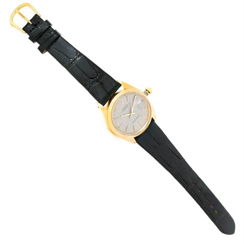 The image shows a Rolex President 1503 Men's Yellow Gold Silver Dial 1503 Men's Yellow Gold Silver Dial model watch from an aerial view, displaying its gold case and black leather strap.