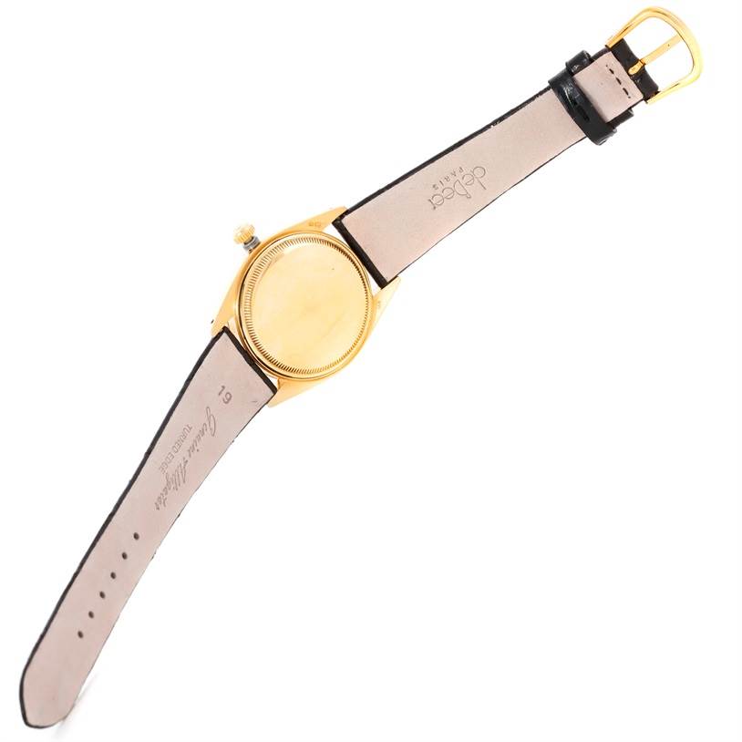 The image shows the back and strap of a Rolex President 1503 Men's Yellow Gold Silver Dial 1503 Men's Yellow Gold Silver Dial model watch, tilted with the dial facing downward.