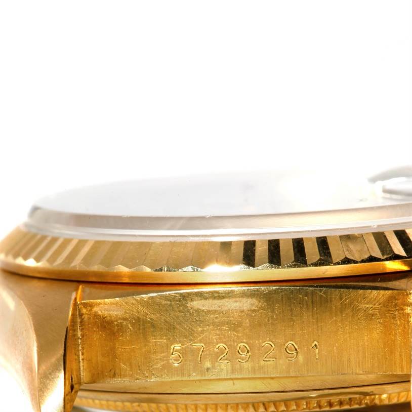 This image shows a close-up side view of the Rolex President 18038 Men's Yellow Gold Blue Dial 18038 Men's Yellow Gold Blue Dial model watch case, including its fluted bezel and serial number.