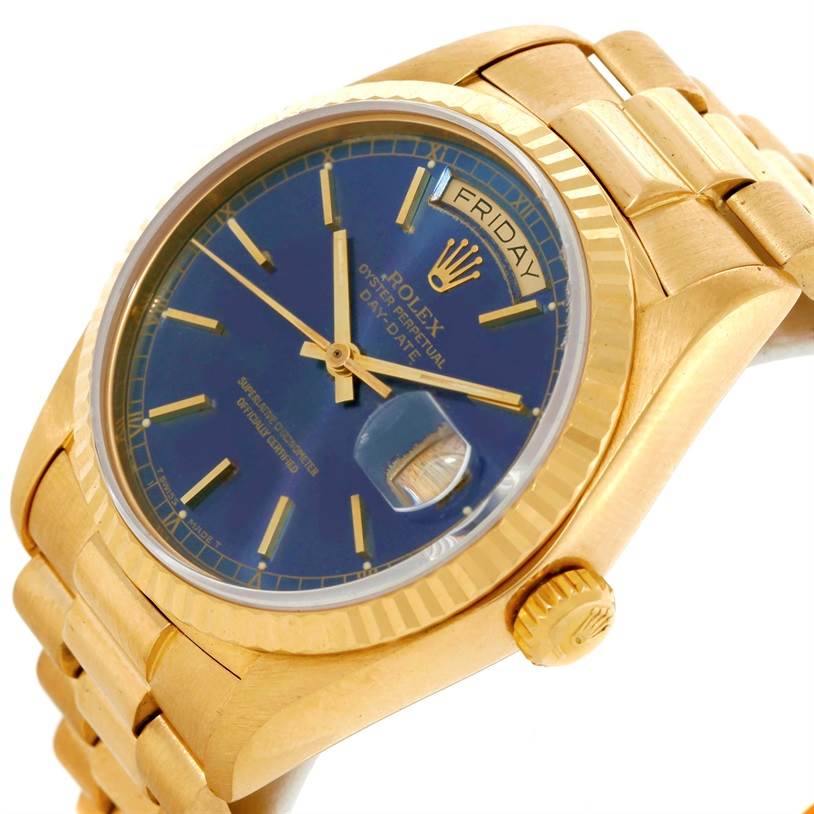 The image shows a tilted view of a Rolex President 18038 Men's Yellow Gold Blue Dial 18038 Men's Yellow Gold Blue Dial model watch, highlighting its blue dial, gold case, crown, and bracelet.