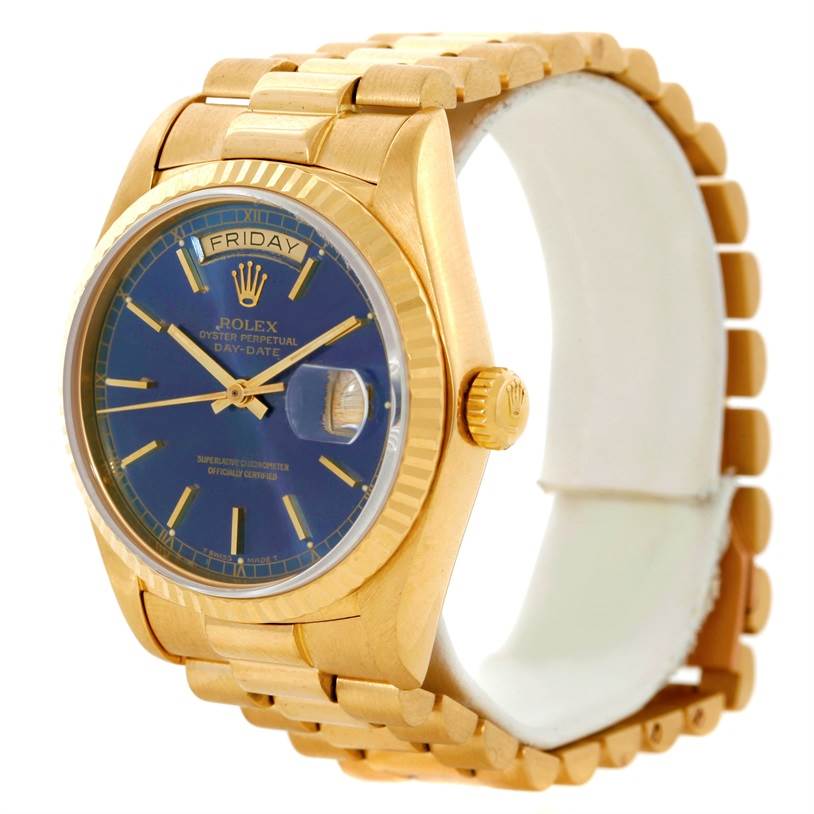 This image shows a Rolex President 18038 Men's Yellow Gold Blue Dial 18038 Men's Yellow Gold Blue Dial model watch at an angle displaying its blue dial, fluted bezel, crown, and President bracelet.