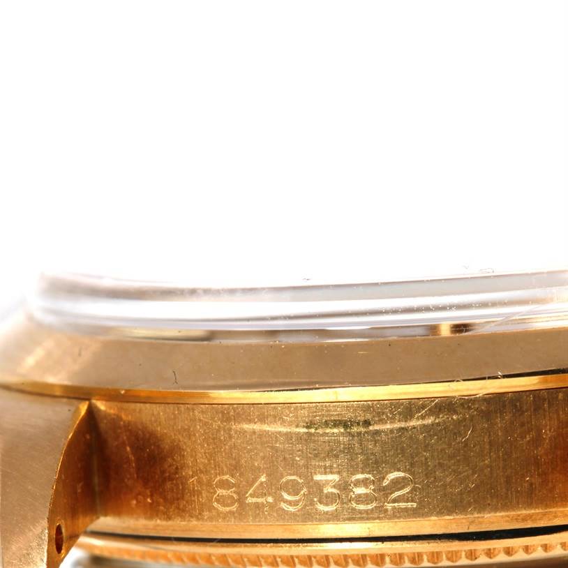 The image shows a close-up side view of the Rolex President 1500 Men
s Yellow Gold Champagne Dial 1500 Men
s Yellow Gold Champagne Dial watch
s case, focusing on its serial number engraving.