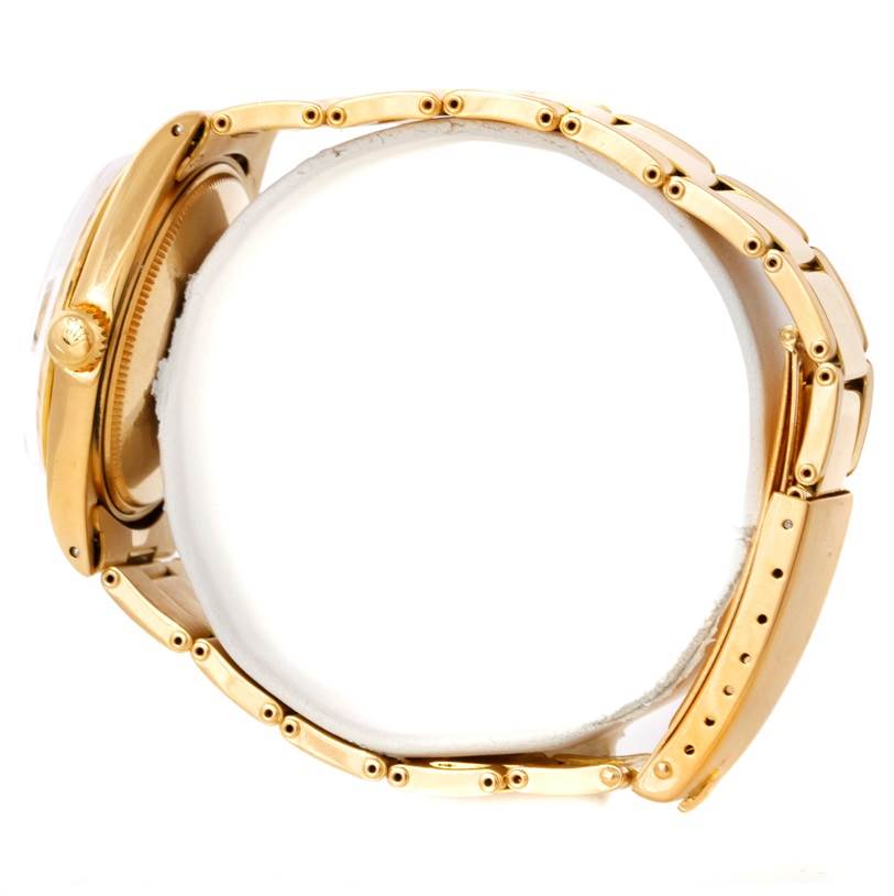 This image shows a President model Rolex watch from a side angle, focusing on the crown and band links.