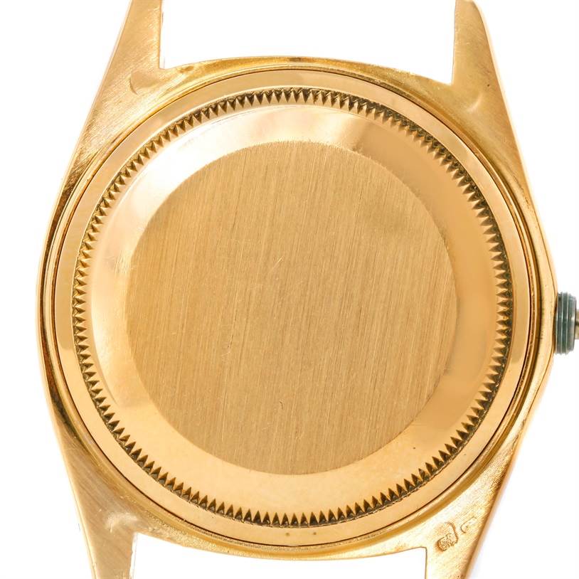 This image shows the case back of a Rolex President 18038 Men's Yellow Gold Black Dial 18038 Men's Yellow Gold Black Dial model watch from a top-down angle.