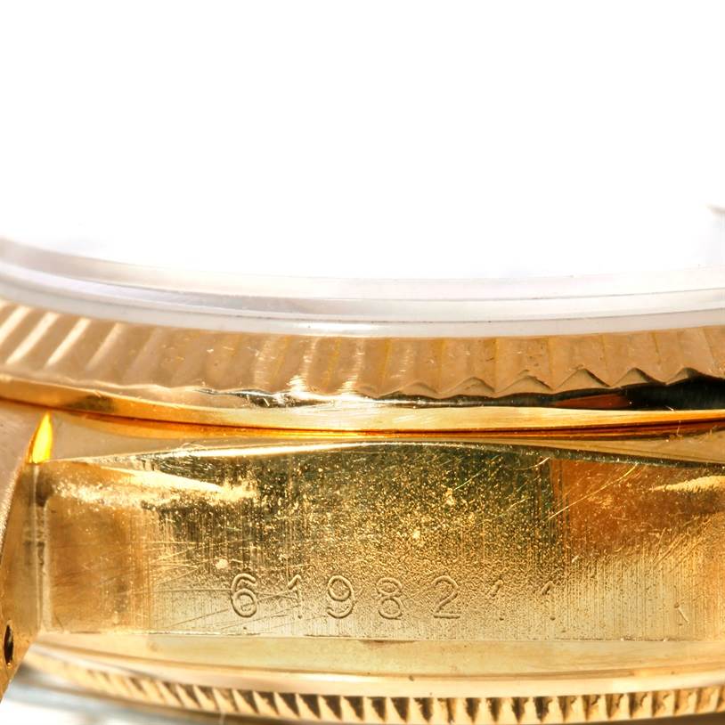 Close-up of the Rolex President 18038 Men's Yellow Gold Black Dial 18038 Men's Yellow Gold Black Dial model showing the serial number on the case and the side of the fluted bezel.