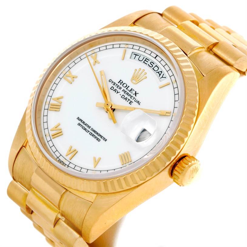 The Rolex President 18038 Men
s Yellow Gold White Dial 18038 Men
s Yellow Gold White Dial model watch is shown from a slightly angled, close-up view displaying the face, crown, and part of the bracelet.
