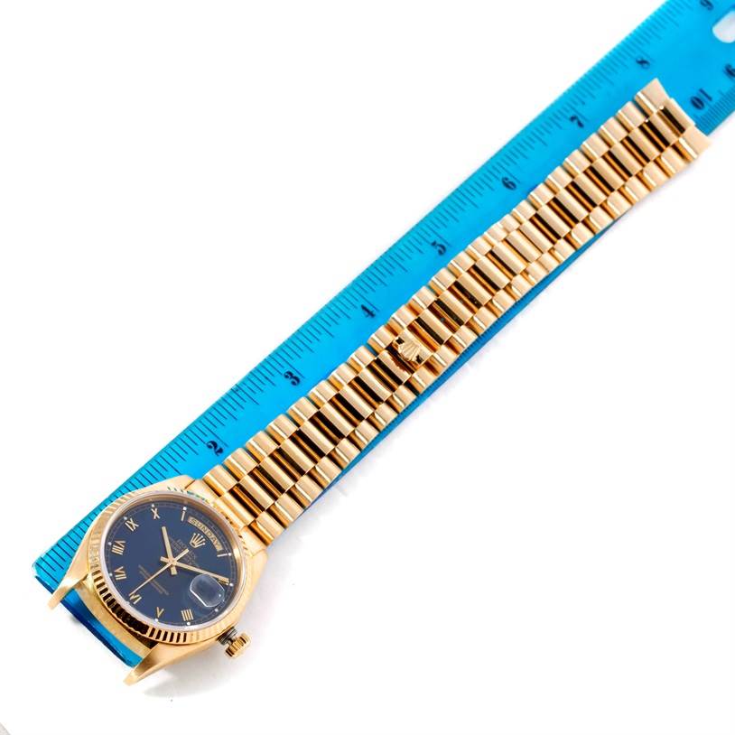 The image shows a Rolex President 18038 Men's Yellow Gold Blue Dial 18038 Men's Yellow Gold Blue Dial model watch with its full bracelet, next to a blue ruler for size reference.