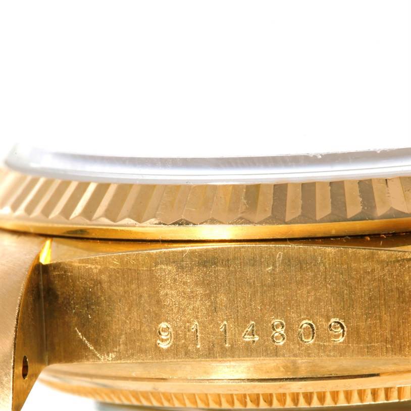 This image shows a close-up of the side of a Rolex President 18038 Men's Yellow Gold Blue Dial 18038 Men's Yellow Gold Blue Dial model watch, focusing on the watch case and serial number.