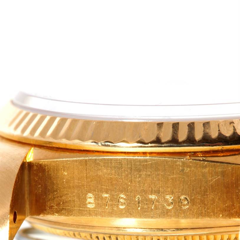 This close-up image of a Rolex President 18038 Men's Yellow Gold Blue Dial 18038 Men's Yellow Gold Blue Dial watch shows the serial number and part of the bezel.