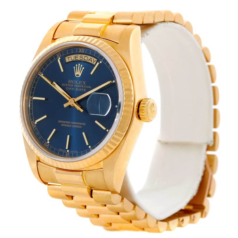 The image shows a Rolex President 18038 Men's Yellow Gold Blue Dial 18038 Men's Yellow Gold Blue Dial model watch at a three-quarter angle emphasizing the gold case, blue dial, and linked bracelet.