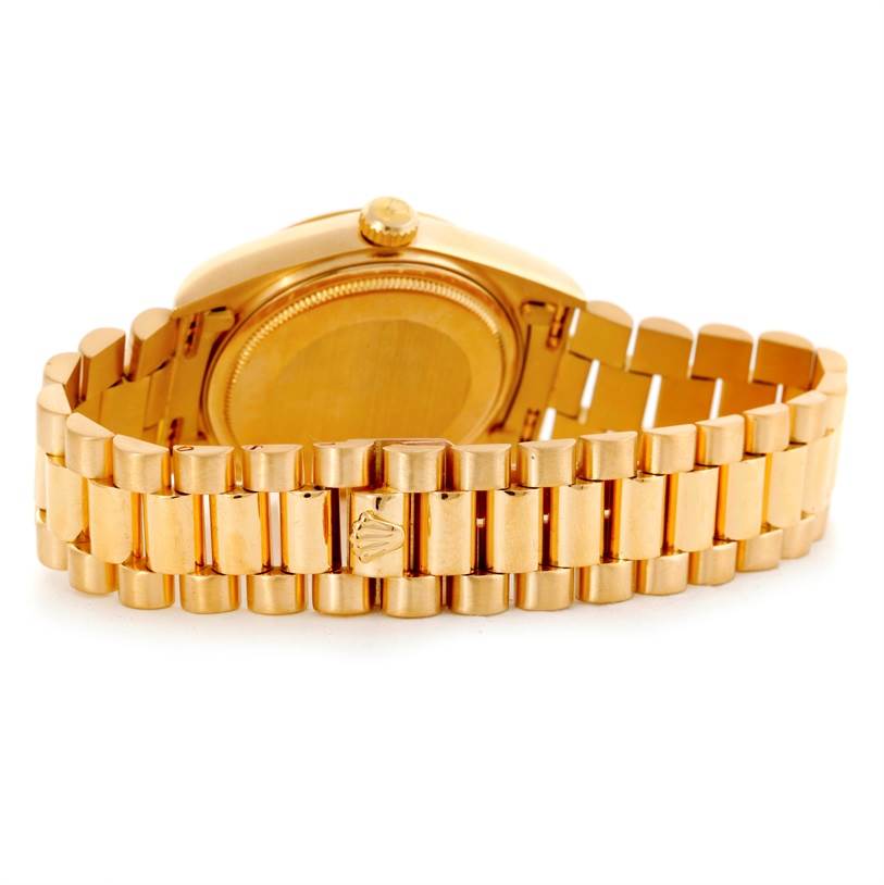 This image shows the back and bracelet of a Rolex President 18038 Men's Yellow Gold Blue Dial 18038 Men's Yellow Gold Blue Dial model watch, featuring its gold case and iconic link design.