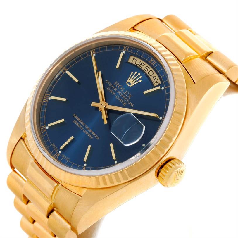This image shows the Rolex President 18038 Men's Yellow Gold Blue Dial 18038 Men's Yellow Gold Blue Dial watch at an angle highlighting the face, crown, and part of the bracelet.