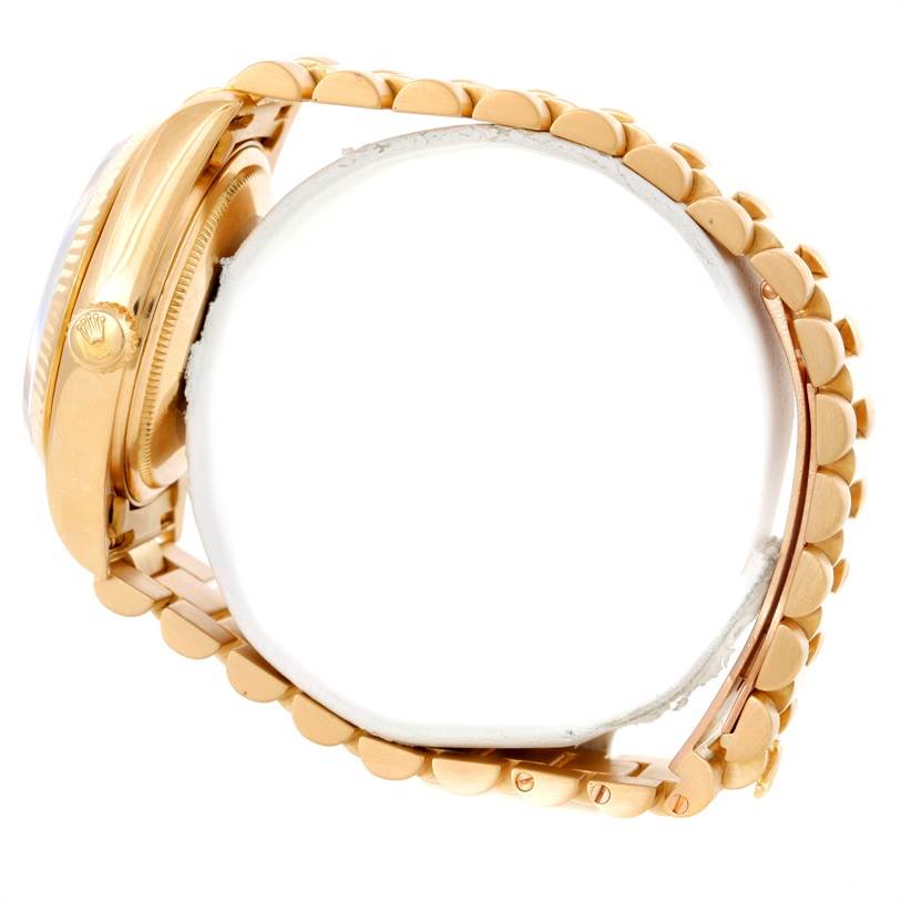 This is a side view of the Rolex President 18038 Men's Yellow Gold Blue Dial 18038 Men's Yellow Gold Blue Dial watch, showing the crown, case, and part of the bracelet.