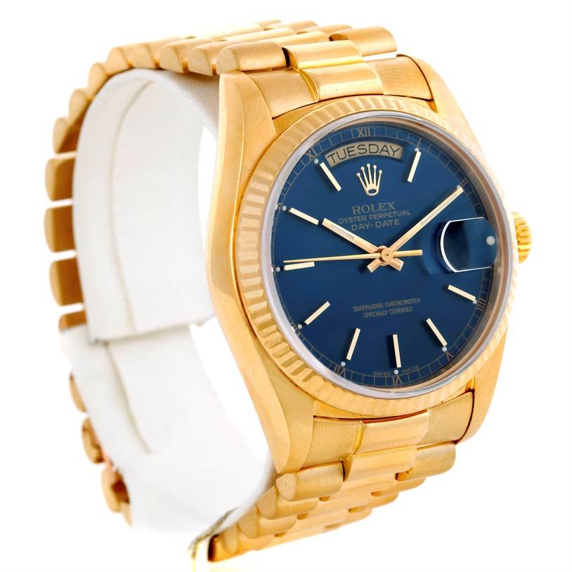 The image shows a side angle of a Rolex President 18038 Men's Yellow Gold Blue Dial 18038 Men's Yellow Gold Blue Dial watch, showcasing its gold bracelet and blue dial with day and date displays.