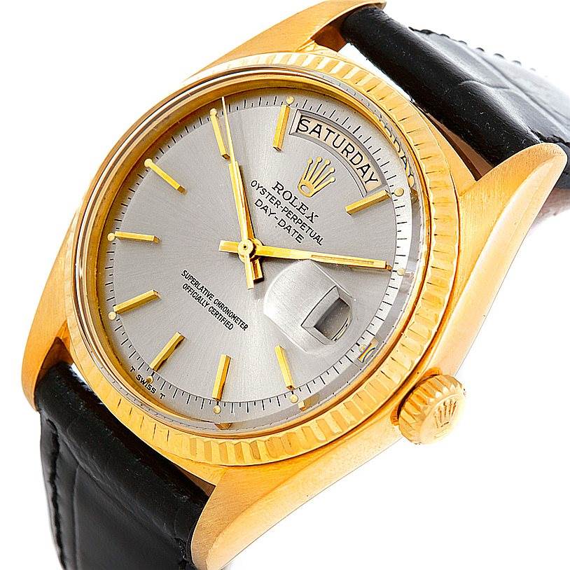 The image shows a close-up of the face of a Rolex President 1803 Men's Yellow Gold Grey Dial 1803 Men's Yellow Gold Grey Dial model watch, showcasing its dial, hands, crown, and part of the strap.