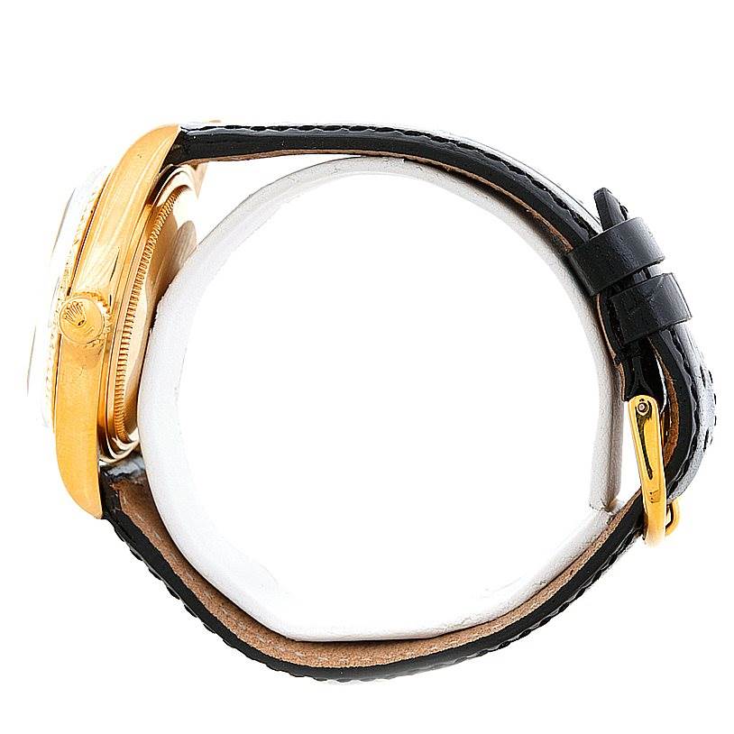 This is a side view of a Rolex President 1803 Men's Yellow Gold Grey Dial 1803 Men's Yellow Gold Grey Dial model showing the gold case, crown, and part of the black leather strap with buckle.