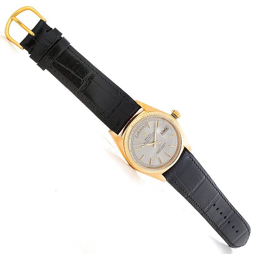 The Rolex President 1803 Men's Yellow Gold Grey Dial 1803 Men's Yellow Gold Grey Dial model watch is shown from a top-down angle, displaying the dial, case, and black leather strap.