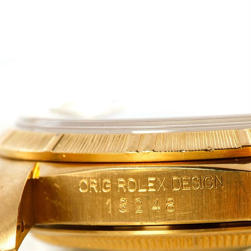 The image shows a close-up angle of the side case of a Rolex President 18248 Men's Yellow Gold Champagne Dial 18248 Men's Yellow Gold Champagne Dial model, highlighting the bezel and inscription.