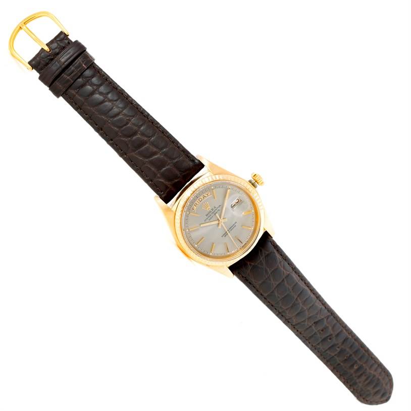 The image shows a top view of a Rolex President 1803 Men's Yellow Gold Grey Dial 1803 Men's Yellow Gold Grey Dial model watch with a gold case and brown leather strap.