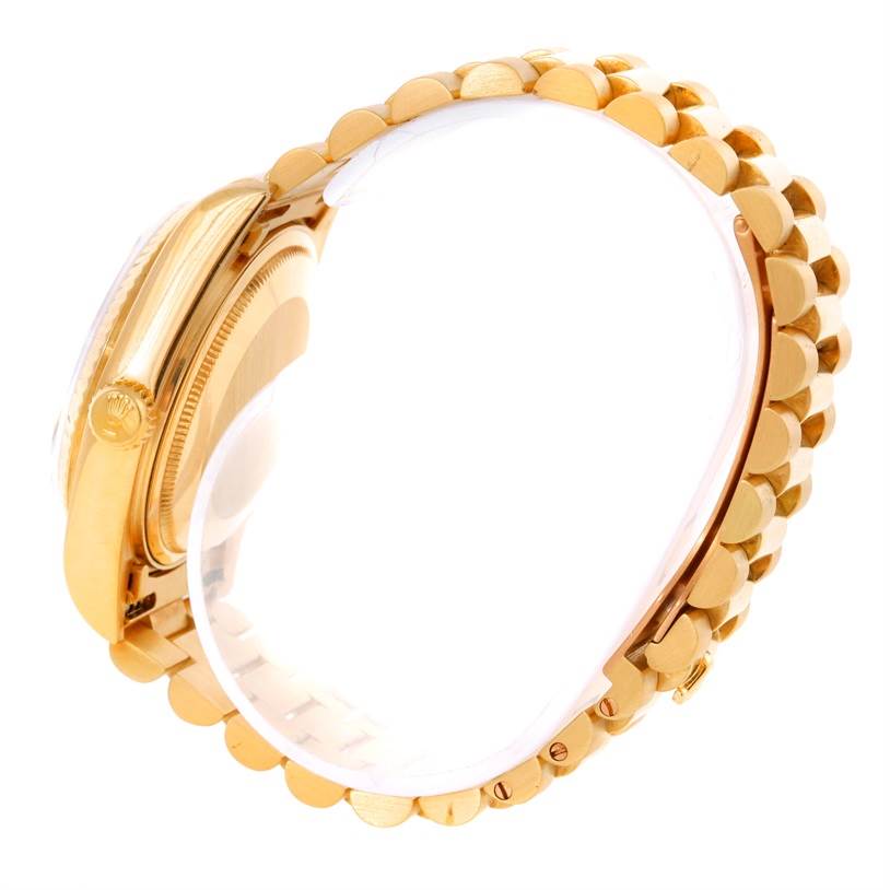 This image shows the side view of a Rolex President 18038 Men
s Yellow Gold Champagne Dial 18038 Men
s Yellow Gold Champagne Dial model watch, including the crown and part of the gold bracelet.