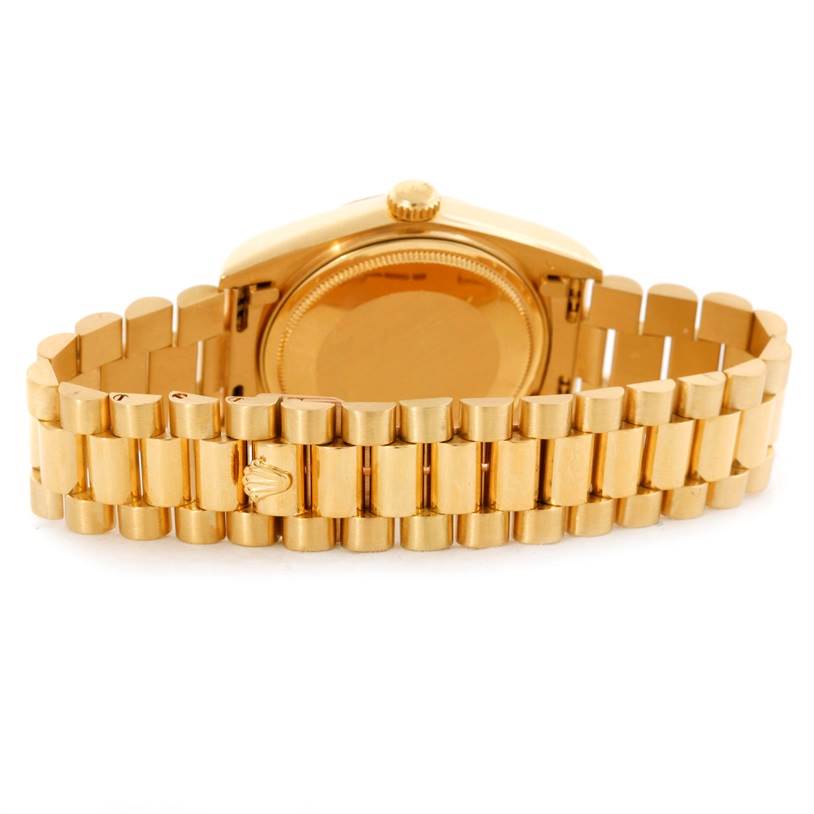 The image shows the rear view of a Rolex President 18038 Men
s Yellow Gold Champagne Dial 18038 Men
s Yellow Gold Champagne Dial model, focusing on the case back and the bracelet.