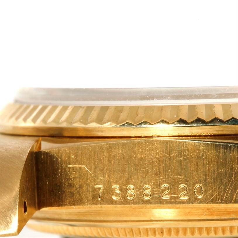 The image shows a side view of a Rolex President 18038 Men
s Yellow Gold Champagne Dial 18038 Men
s Yellow Gold Champagne Dial watch, highlighting the case and bezel with engraved numbers.