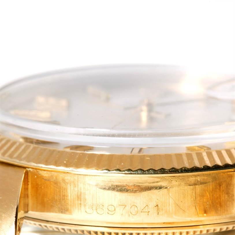 The image shows a close-up, side angle of the case and part of the dial of a Rolex President 1503 Men
s Yellow Gold Silver Dial 1503 Men
s Yellow Gold Silver Dial watch, focusing on the watch
s serial number.