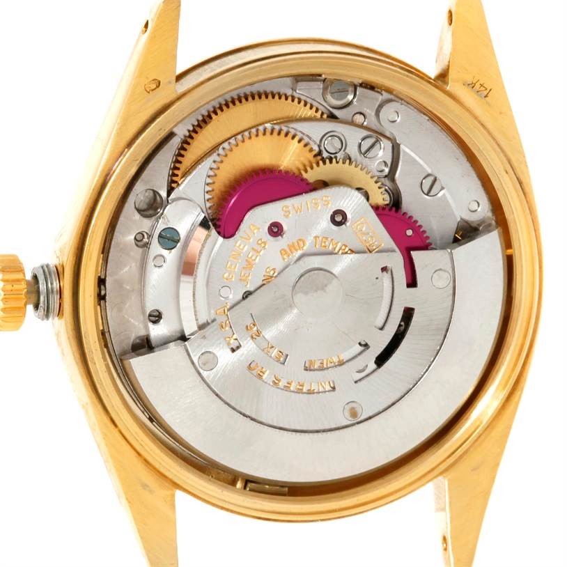The image shows the internal mechanical movement of a Rolex President 1503 Men
s Yellow Gold Silver Dial 1503 Men
s Yellow Gold Silver Dial watch from a top-down angle, highlighting gears and other components.