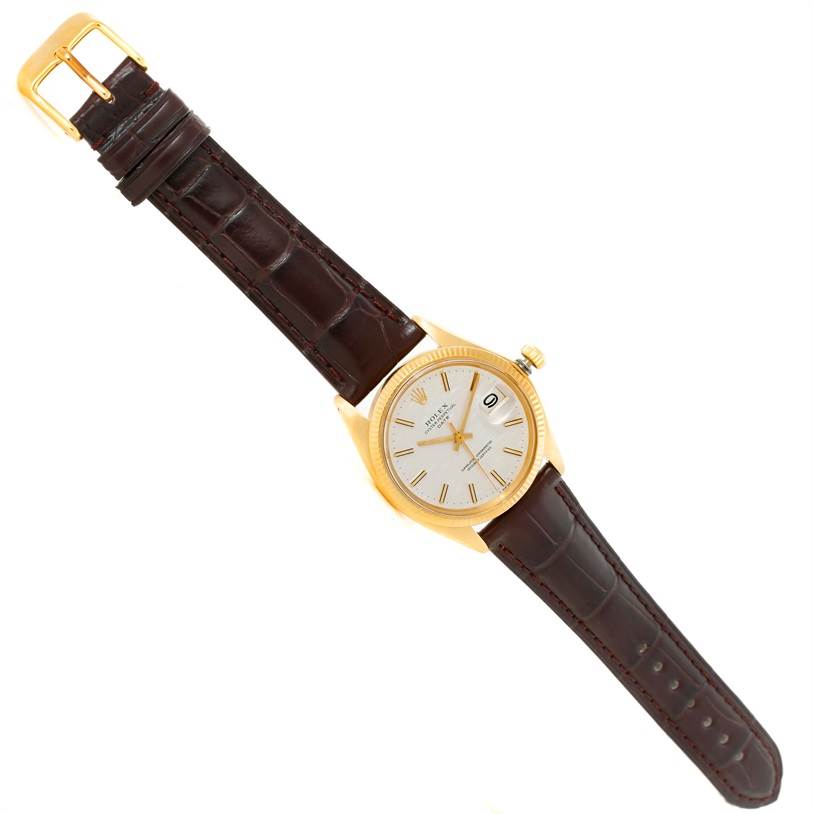 The image shows a top-down view of a Rolex President 1503 Men
s Yellow Gold Silver Dial 1503 Men
s Yellow Gold Silver Dial watch, highlighting the dial, bezel, crown, and leather strap.