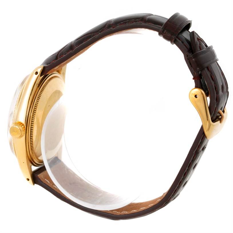 This image shows a side view of a Rolex President 1503 Men
s Yellow Gold Silver Dial 1503 Men
s Yellow Gold Silver Dial model watch, highlighting the case, crown, and leather strap with a gold buckle.