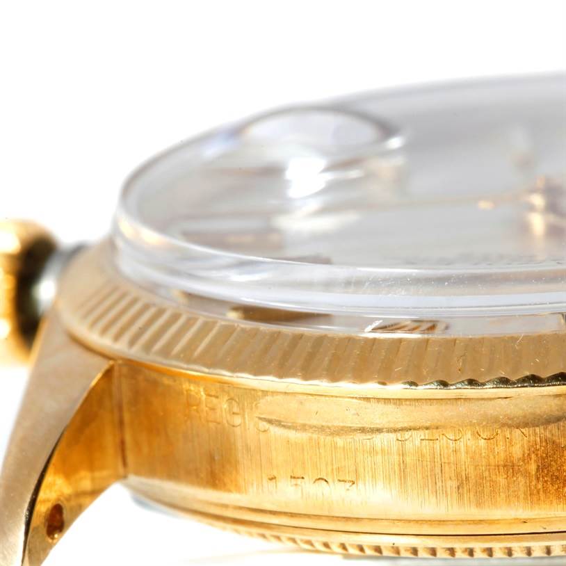 This close-up image shows the side of a Rolex President 1503 Men
s Yellow Gold Silver Dial 1503 Men
s Yellow Gold Silver Dial model watch, highlighting the case, bezel, and part of the crystal.