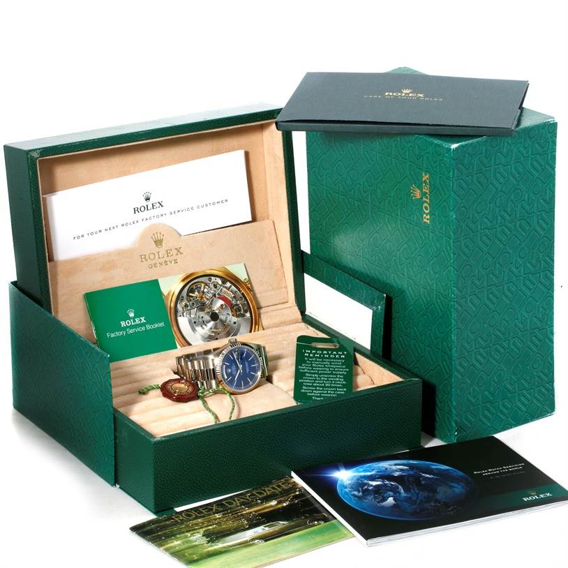 The image shows a Rolex President 18239 Men's White Gold Blue Dial 18239 Men's White Gold Blue Dial model watch and its accessories from a top-down angle, including its box and booklets.