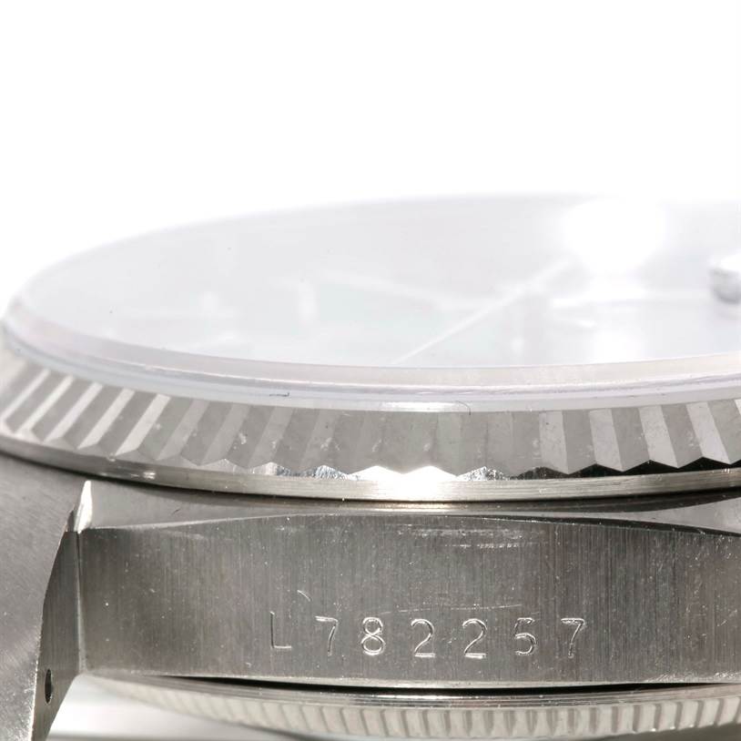 This image shows a close-up side view of the Rolex President 18239 Men's White Gold Blue Dial 18239 Men's White Gold Blue Dial model watch, highlighting its bezel and partially visible serial number.