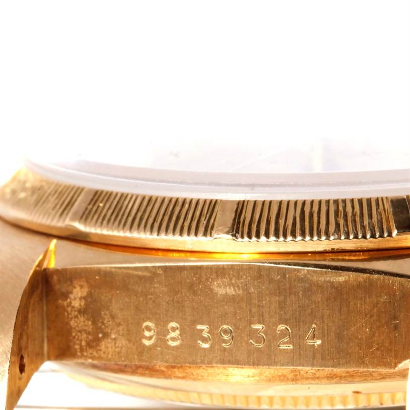 The image shows a close-up, side-angle view of the Rolex President 18078 Men
s Yellow Gold Champagne Dial 18078 Men
s Yellow Gold Champagne Dial model watch, highlighting a section of its case and engraved serial number.