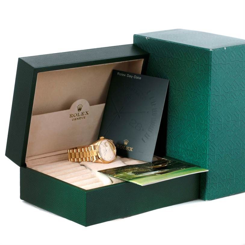 The image shows a Rolex President 18078 Men
s Yellow Gold Champagne Dial 18078 Men
s Yellow Gold Champagne Dial model watch in its open green box with associated papers and documentation.