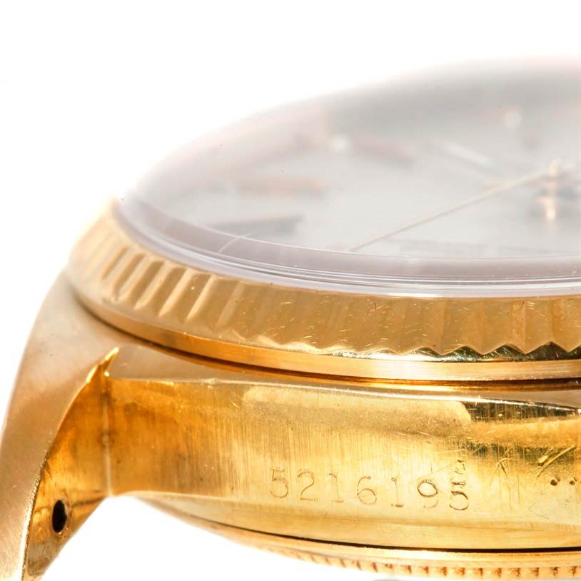 This close-up shot of the Rolex President 16018 Men
s Yellow Gold Silver Dial 16018 Men
s Yellow Gold Silver Dial model watch shows the side of the case, bezel, and part of the dial.