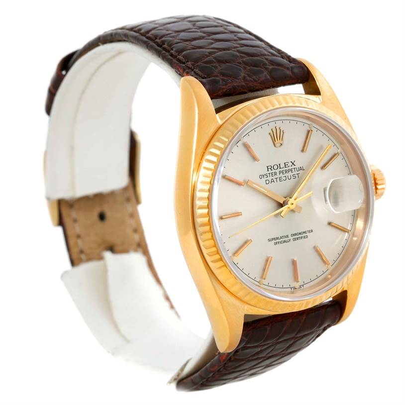This Rolex President 16018 Men
s Yellow Gold Silver Dial 16018 Men
s Yellow Gold Silver Dial model watch is shown from an angled side view, highlighting its gold case, white dial, and brown leather strap.
