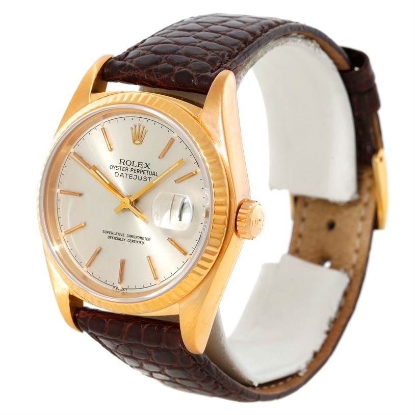 The image shows a Rolex President 16018 Men
s Yellow Gold Silver Dial 16018 Men
s Yellow Gold Silver Dial Datejust watch at an angled view, highlighting its face, bezel, crown, and leather strap.