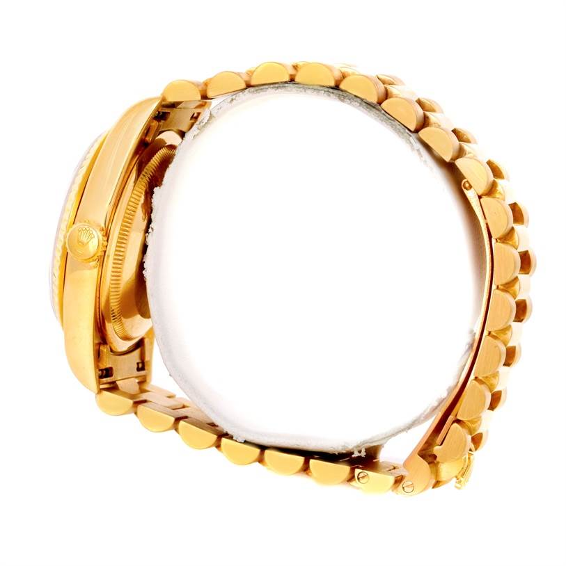 The image shows a side view of a Rolex President 18238 Men
s Yellow Gold Champagne Dial 18238 Men
s Yellow Gold Champagne Dial model watch, focusing on the gold bracelet and crown.