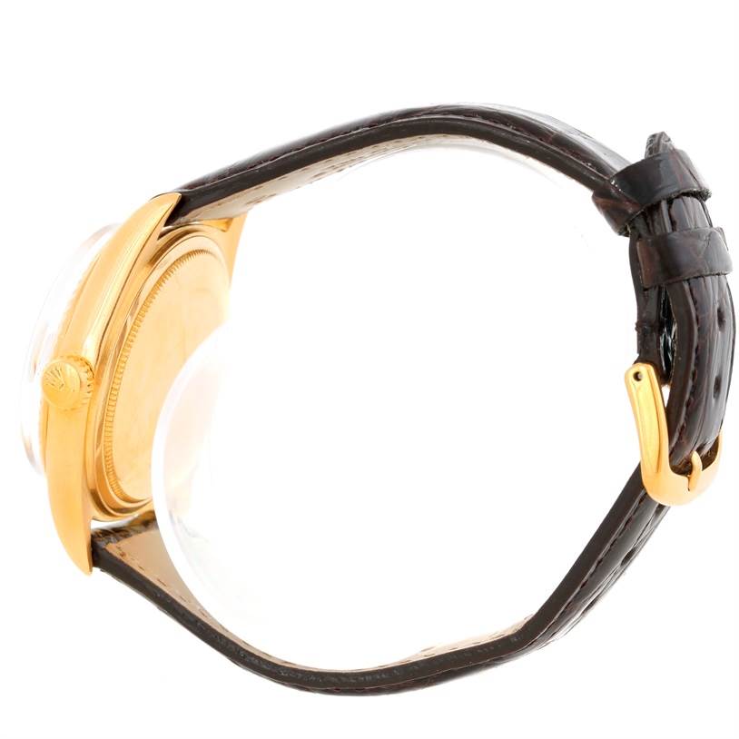 The image shows a side profile of the Rolex President 1803 Men
s Yellow Gold Silver Dial 1803 Men
s Yellow Gold Silver Dial model watch, highlighting its gold case, crown, and leather strap with a gold buckle.