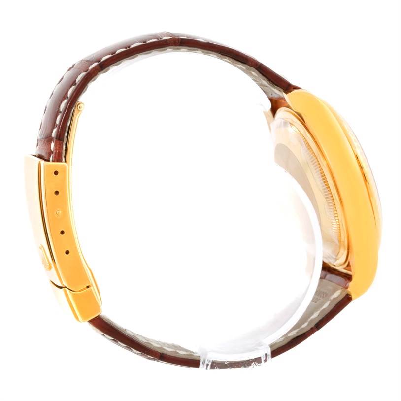 This side-angle image of the Rolex President 116138 Men's Yellow Gold White Dial 116138 Men's Yellow Gold White Dial model shows the brown leather strap, gold case, and clasp.