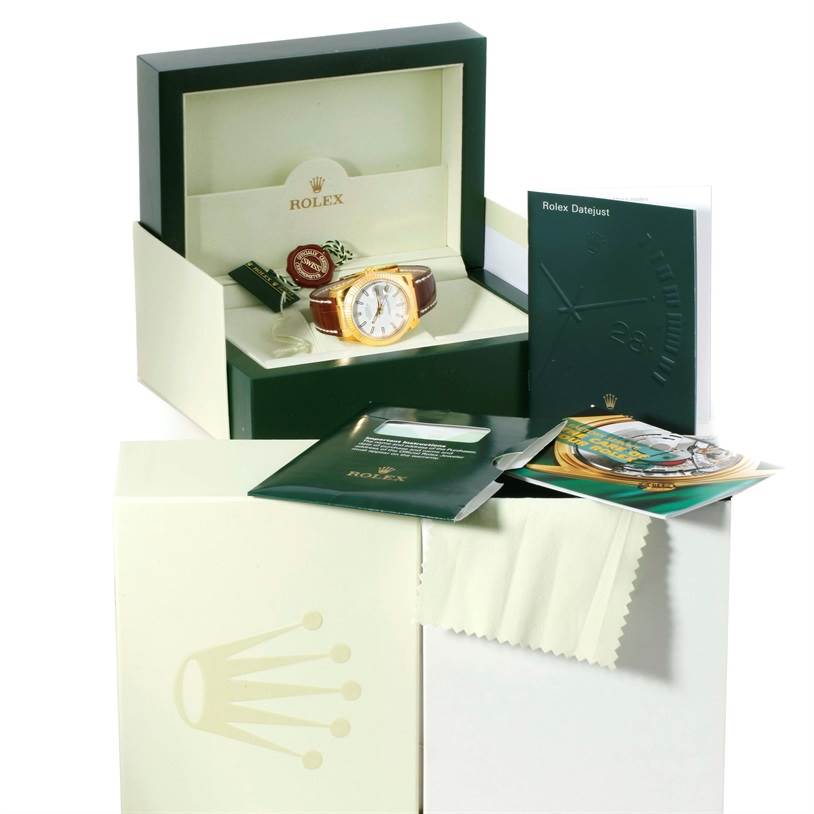 The image shows a Rolex President 116138 Men's Yellow Gold White Dial 116138 Men's Yellow Gold White Dial watch in a box with accompanying booklets and accessories.