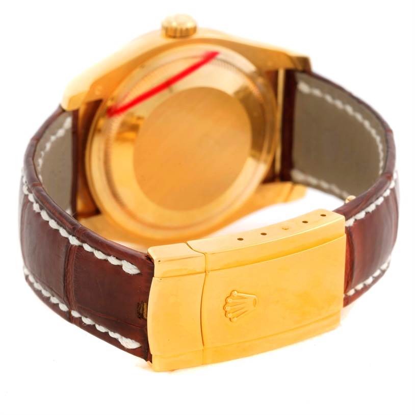 This image shows the back and clasp of a Rolex President 116138 Men's Yellow Gold White Dial 116138 Men's Yellow Gold White Dial model watch, highlighting the gold case and brown leather strap.