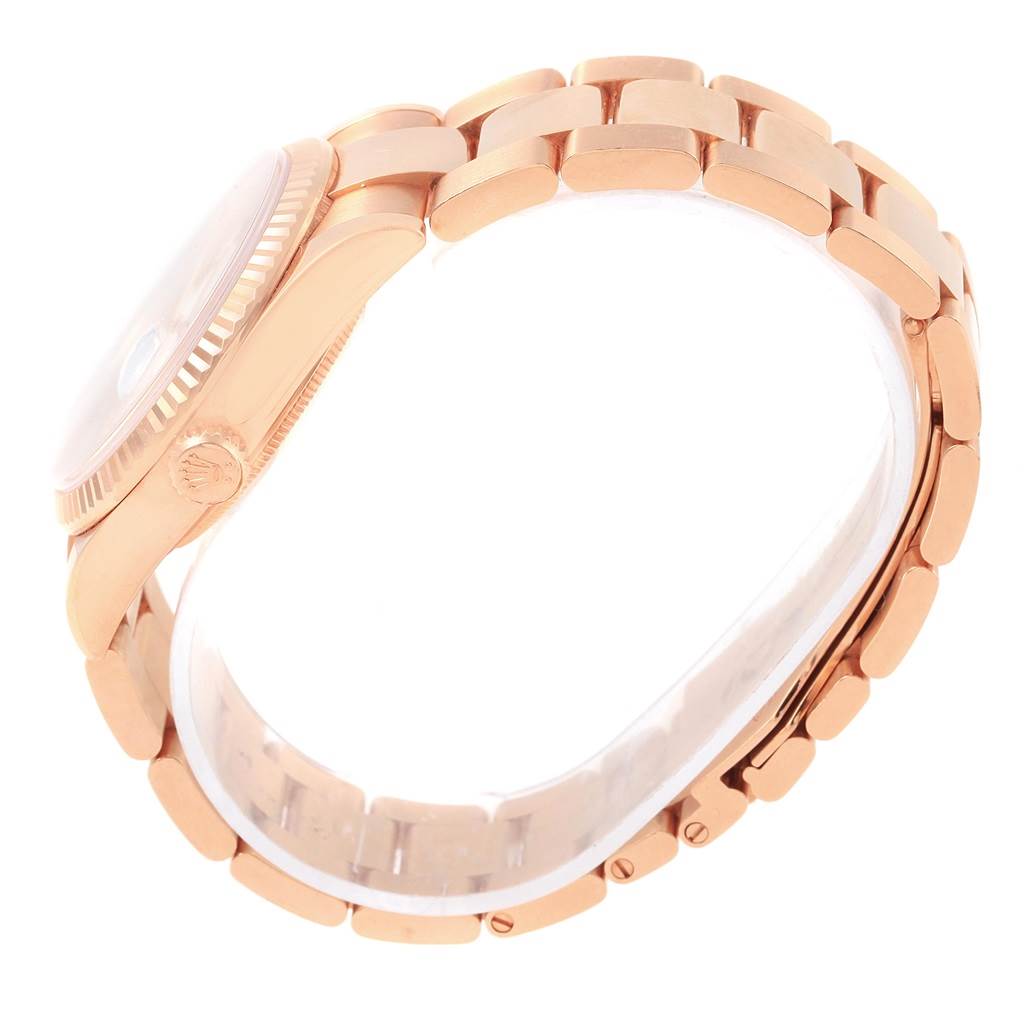 The image shows a side angle of a Rolex President 118235 Men's Rose Gold White Dial 118235 Men's Rose Gold White Dial model watch, emphasizing its metal bracelet and case.