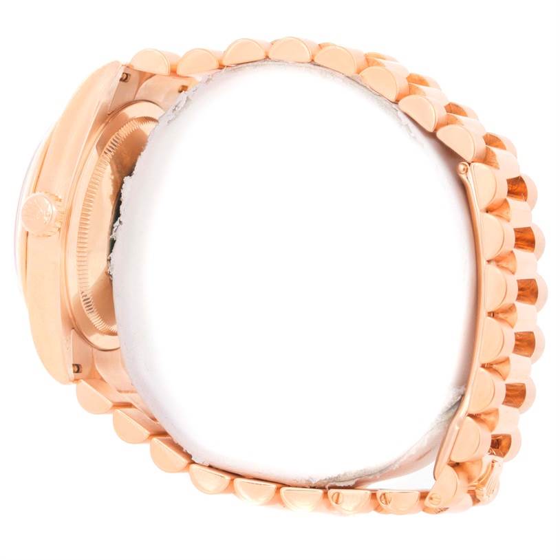 The image shows a side view of a Rolex President 118205 Men's Rose Gold Black Dial 118205 Men's Rose Gold Black Dial watch, emphasizing the crown and the bracelet.