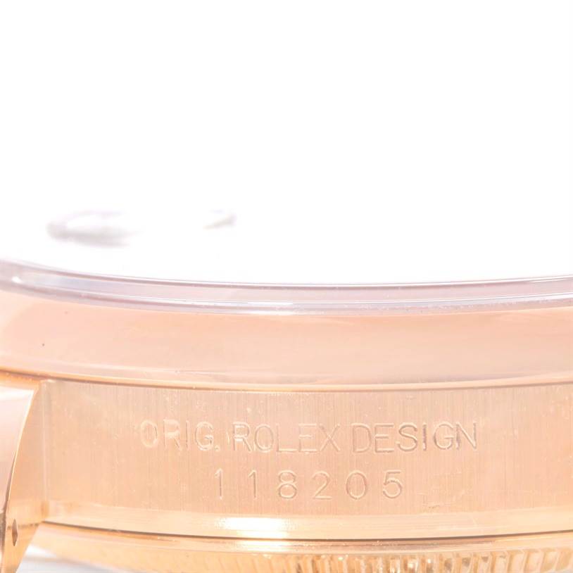 This image shows a close-up of the case side and serial number of a Rolex President 118205 Men's Rose Gold Black Dial 118205 Men's Rose Gold Black Dial model watch.