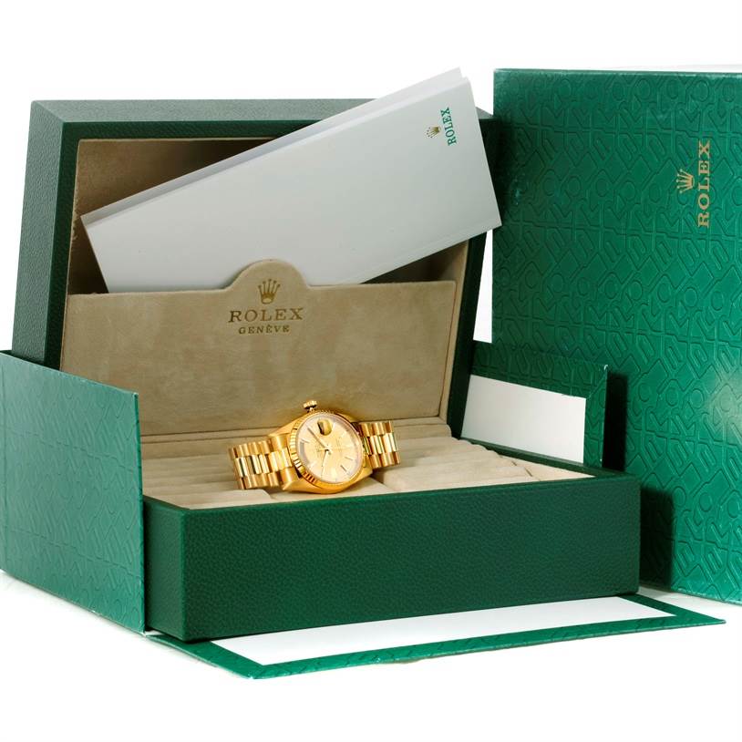 The image shows a Rolex President 18238 Men
s Yellow Gold Champagne Dial 18238 Men
s Yellow Gold Champagne Dial model watch, presented inside an open, green Rolex box with warranty card and booklets.