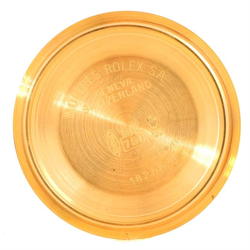 The image shows the case back of a Rolex President 18238 Men
s Yellow Gold Champagne Dial 18238 Men
s Yellow Gold Champagne Dial watch, displaying engraved details and hallmark stamps.